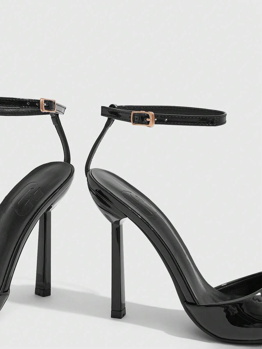 Women's black patent leather high heels sandals featuring lace up ankle straps, open toe, and stiletto heel.