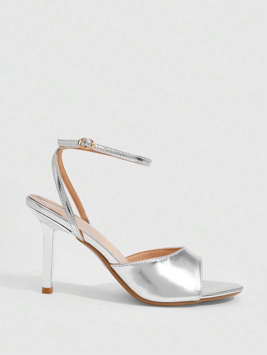 Pair of women's black high heel sandals with open toe design, slim stiletto heel, and adjustable ankle buckle strap.