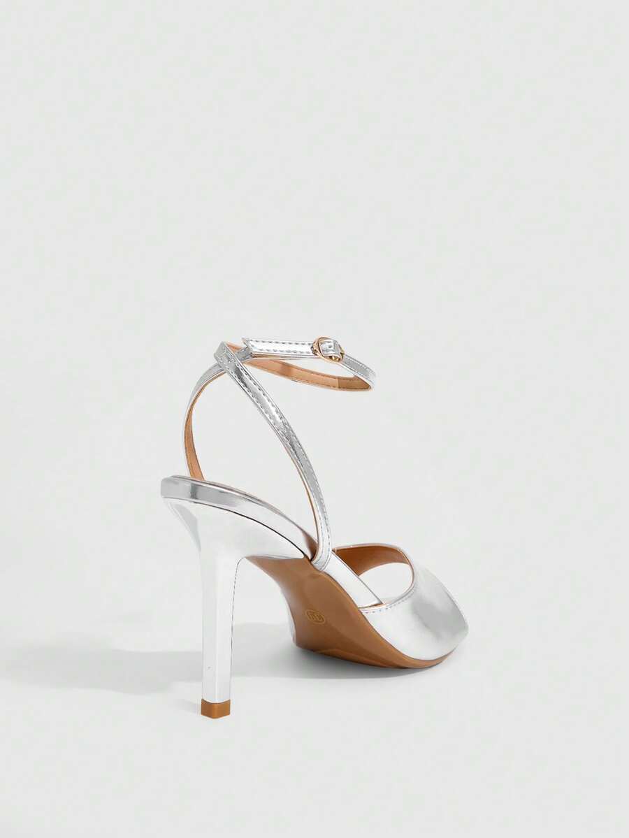Pair of women's black high heel sandals with open toe design, slim stiletto heel, and adjustable ankle buckle strap.