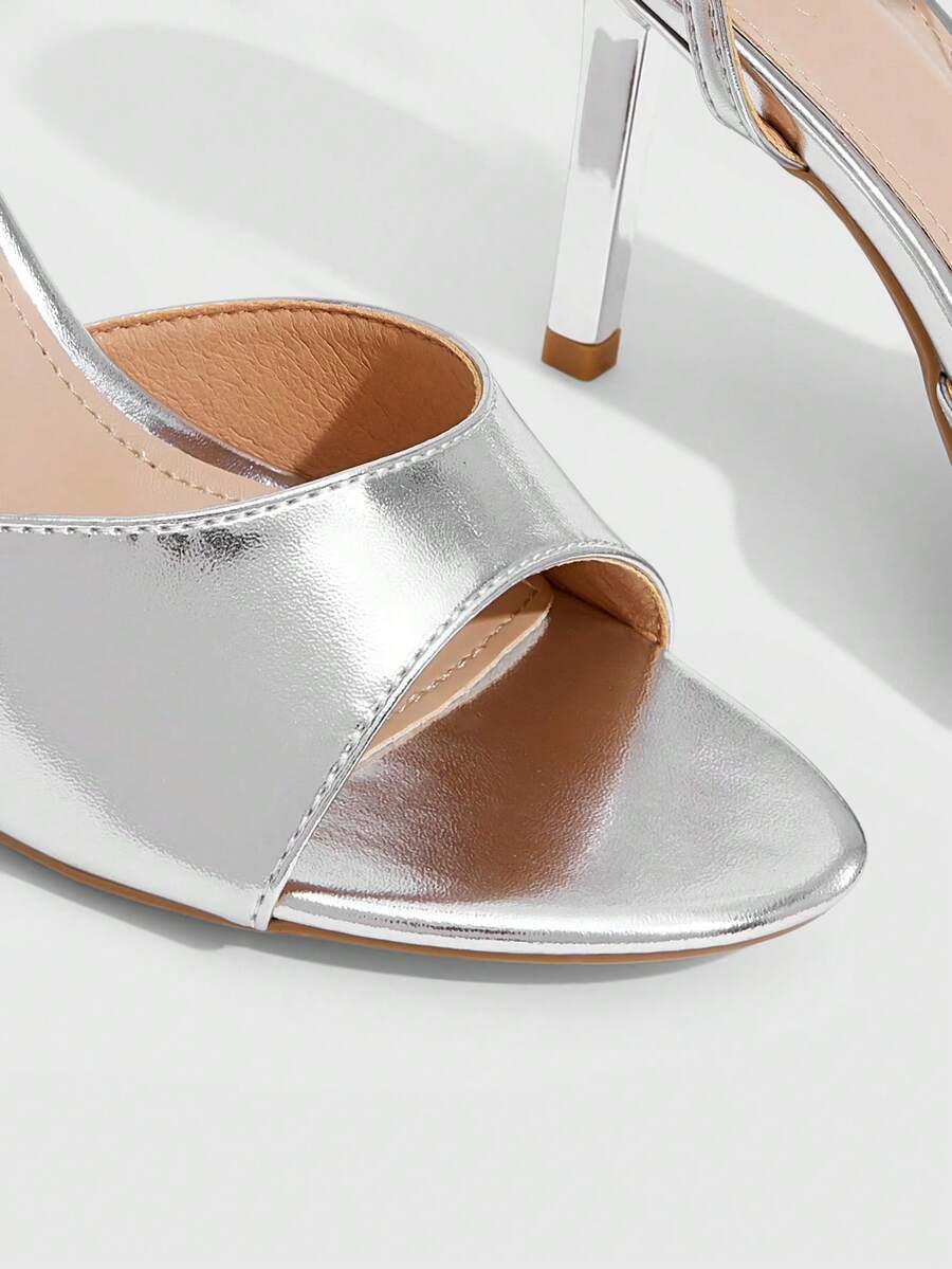 Pair of women's black high heel sandals with open toe design, slim stiletto heel, and adjustable ankle buckle strap.