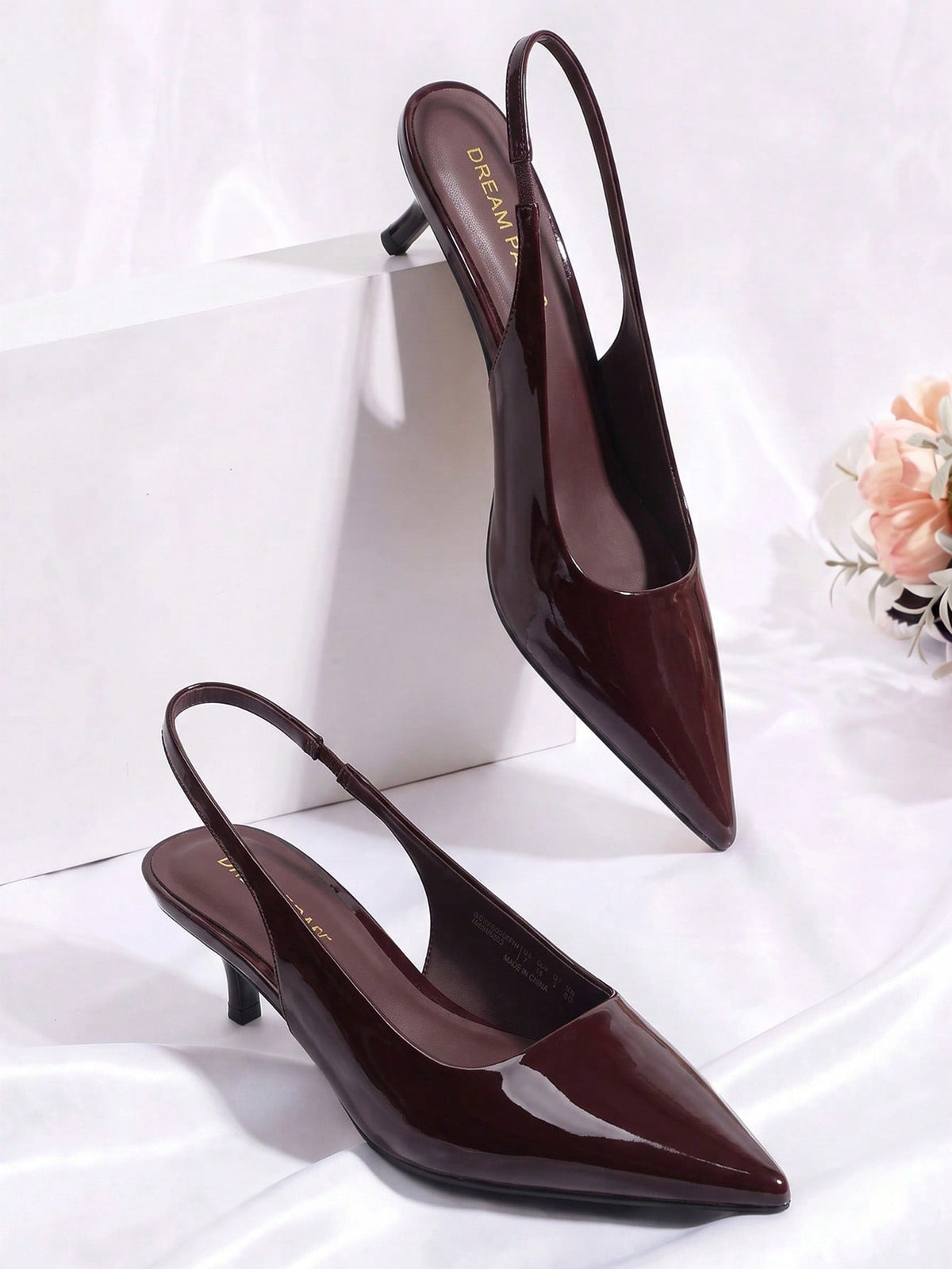 Pointed toe slingback kitten heel pumps in burgundy patent leather with low heel and slip-on strap for women