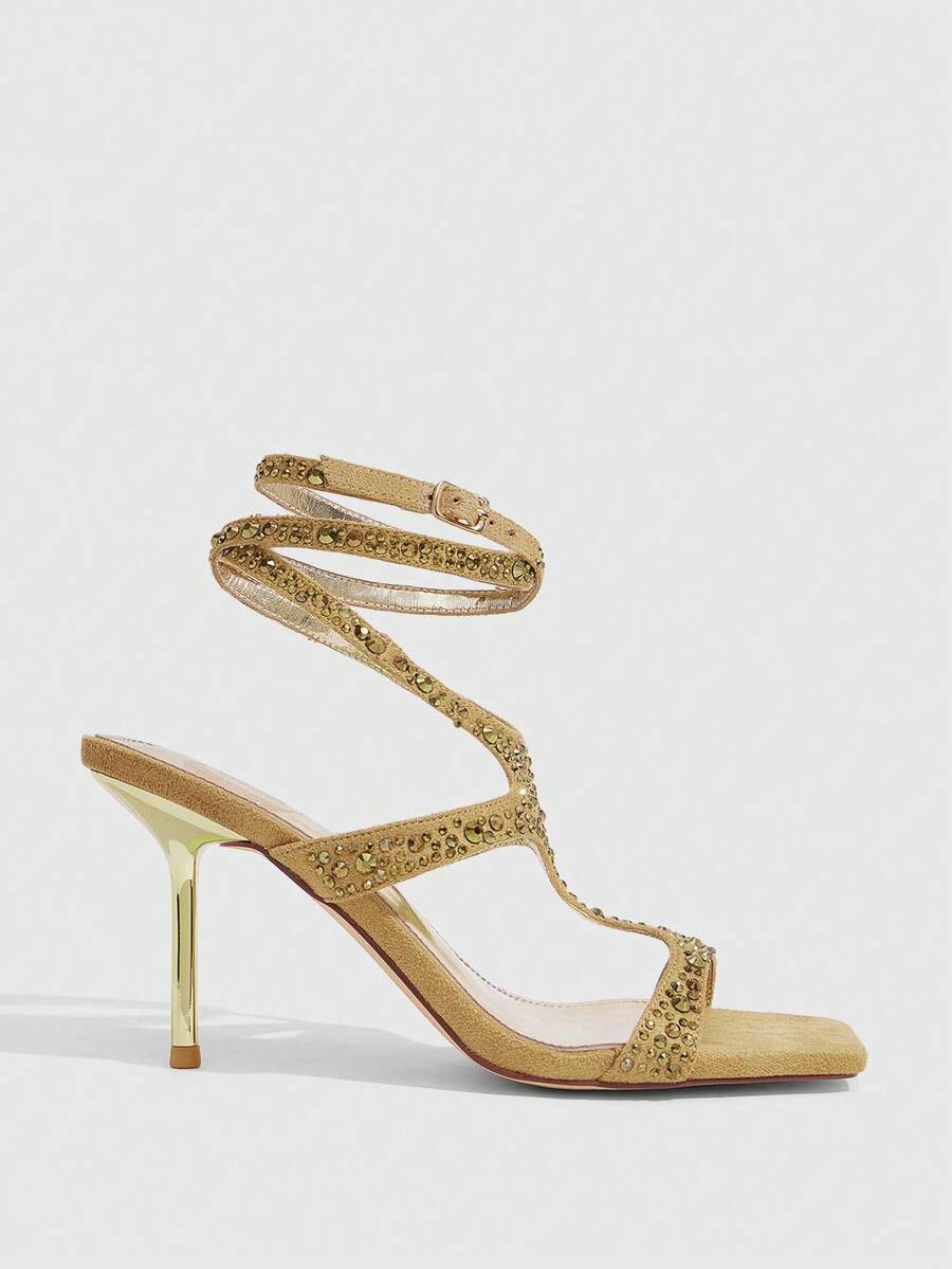 Square toe stiletto sandals featuring rhinestone straps, open toe design, and ankle wrap closures.