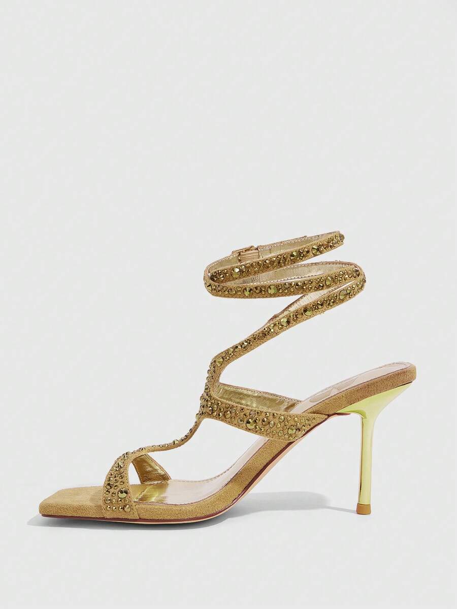 Square toe stiletto sandals featuring rhinestone straps, open toe design, and ankle wrap closures.
