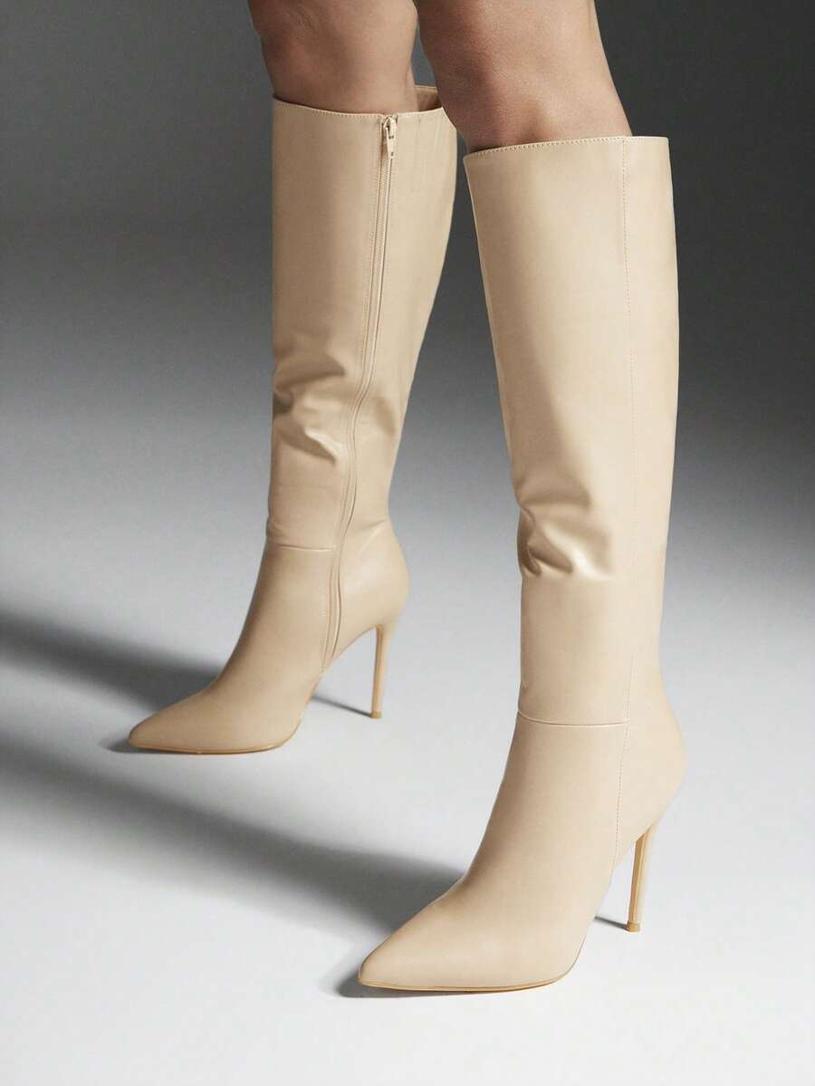 Women's black pointy toe stiletto heel boots featuring a side zipper closure and sleek faux leather finish.