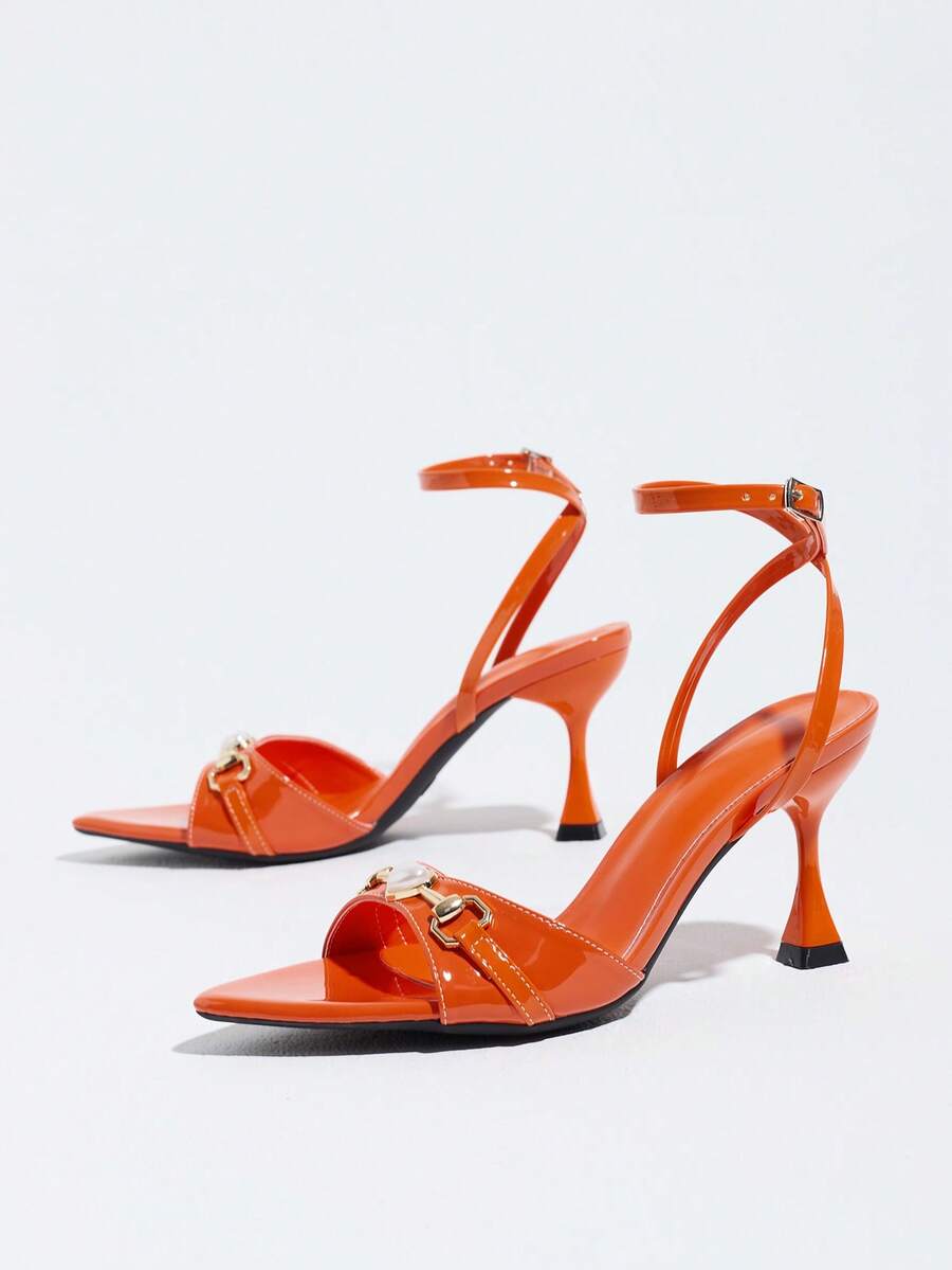 Burgundy open-toe high heels featuring an adjustable ankle strap with buckle closure and high stiletto heel.