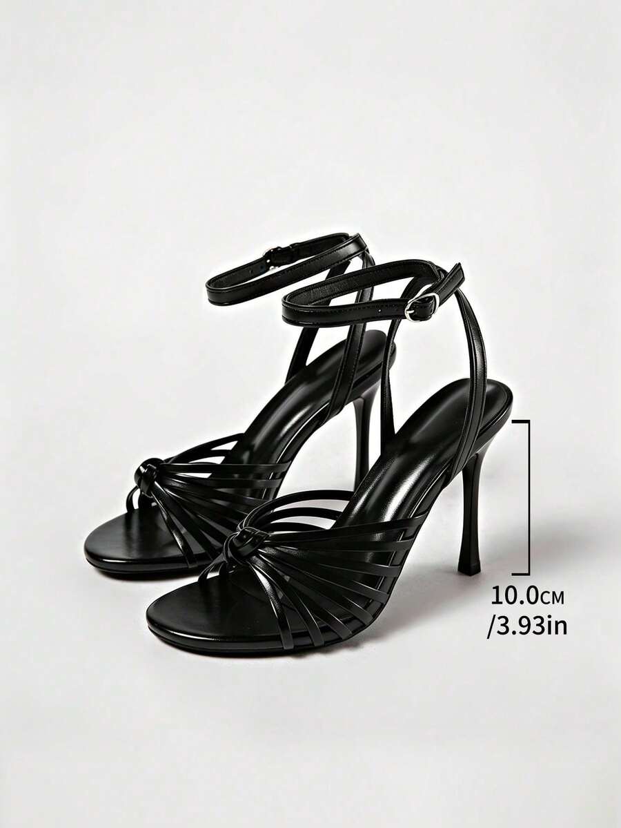 Women's open toe stiletto high heel sandals featuring metallic knot decor and an adjustable ankle buckle strap.