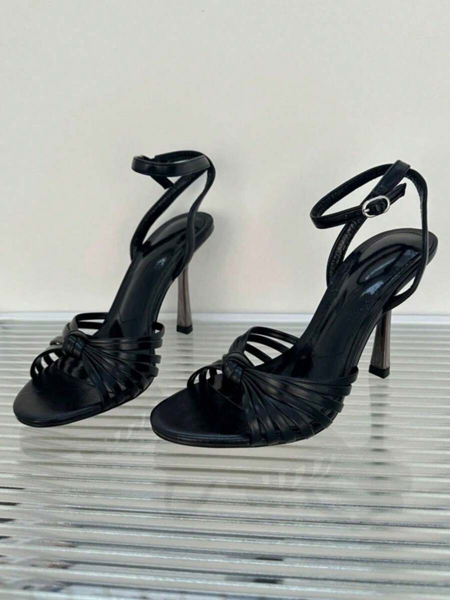 Women's open toe stiletto high heel sandals featuring metallic knot decor and an adjustable ankle buckle strap.