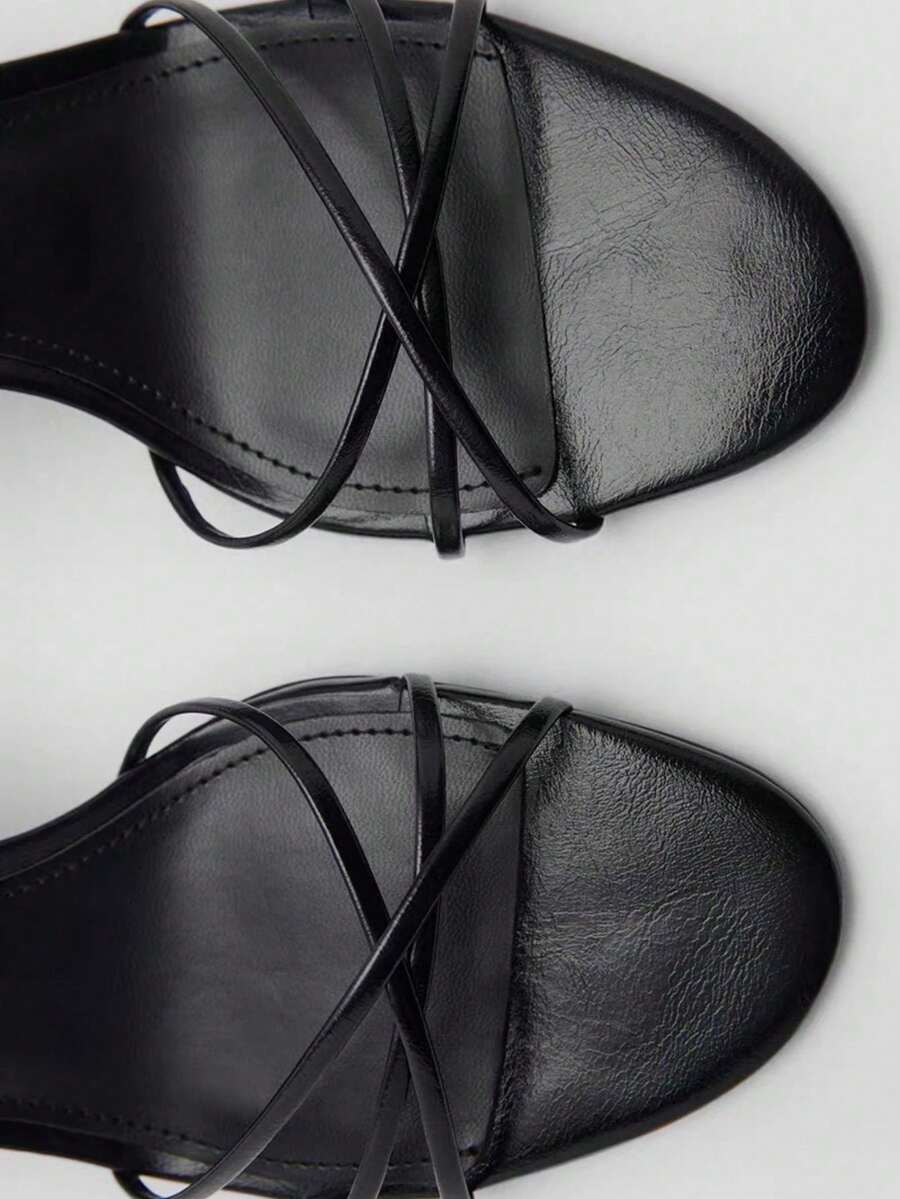 Women's open toe stiletto high heel sandals featuring metallic knot decor and an adjustable ankle buckle strap.
