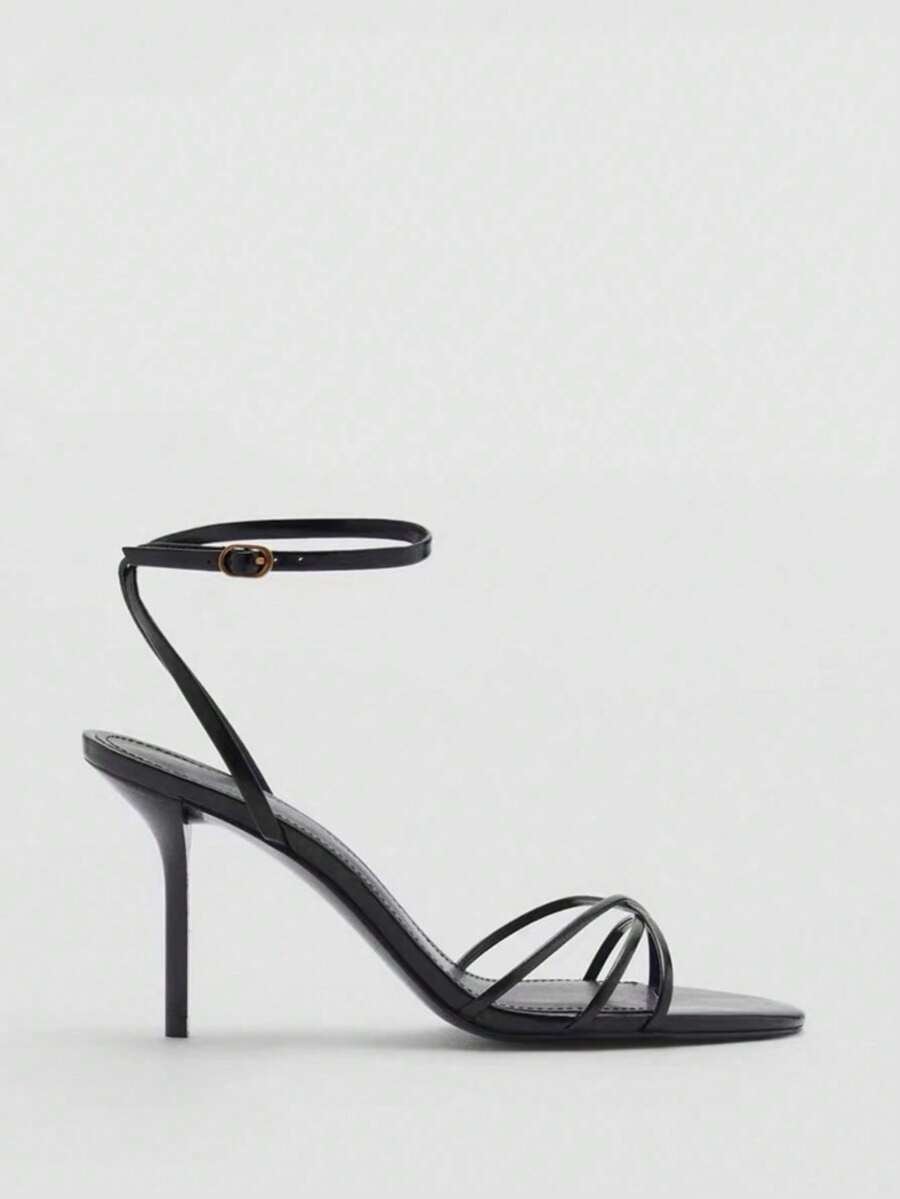 Women's open toe stiletto high heel sandals featuring metallic knot decor and an adjustable ankle buckle strap.