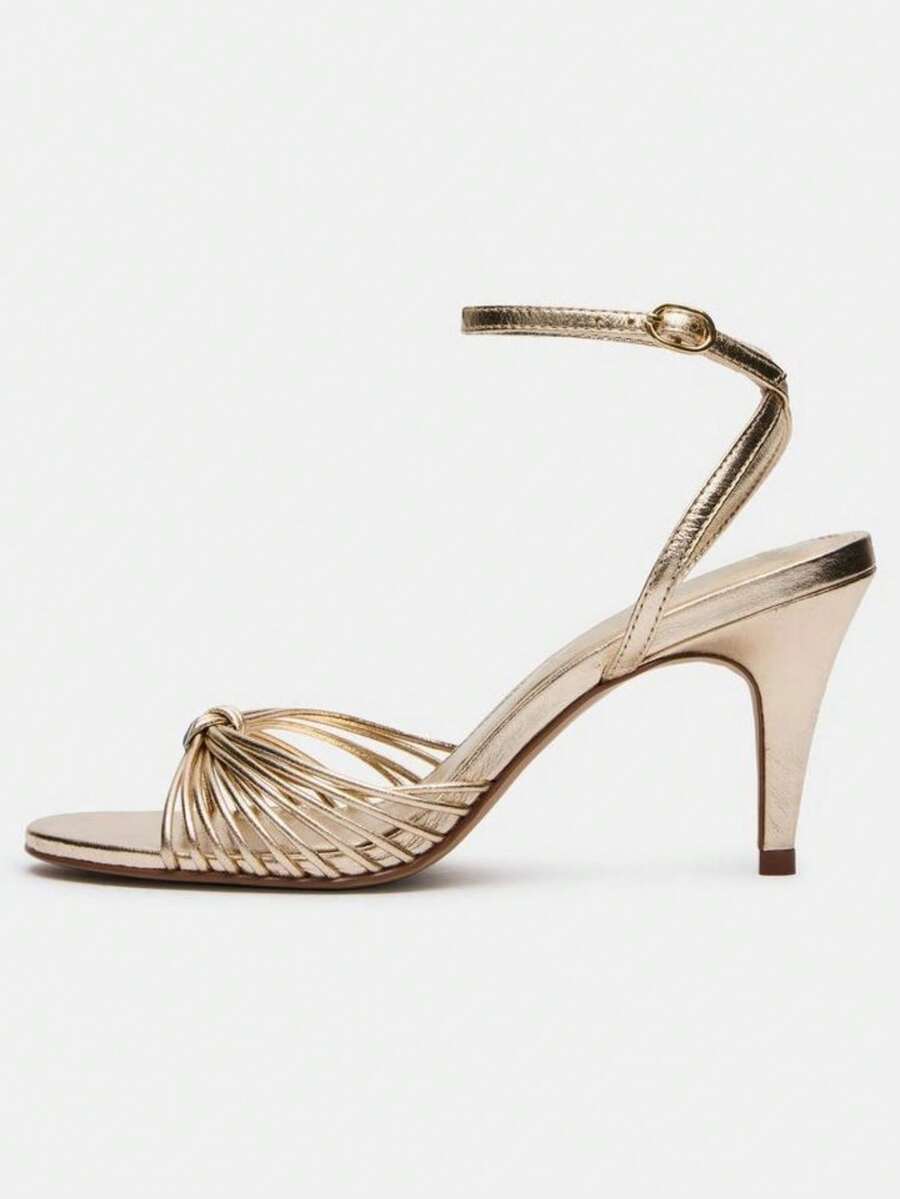 Women's open toe stiletto high heel sandals featuring metallic knot decor and an adjustable ankle buckle strap.