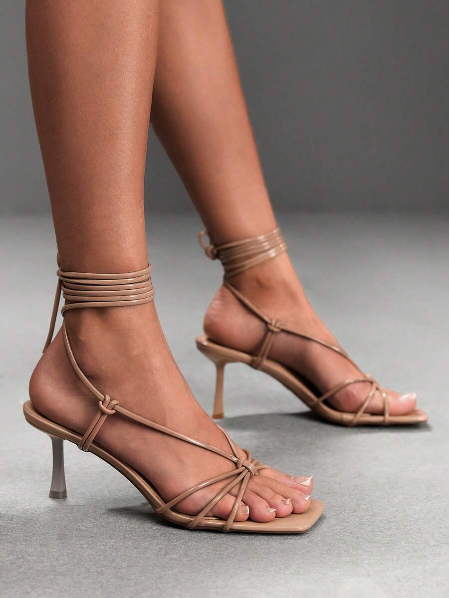 Women's square toe stiletto heel slingback sandals featuring sleek straps and buckle closure in a backless design.