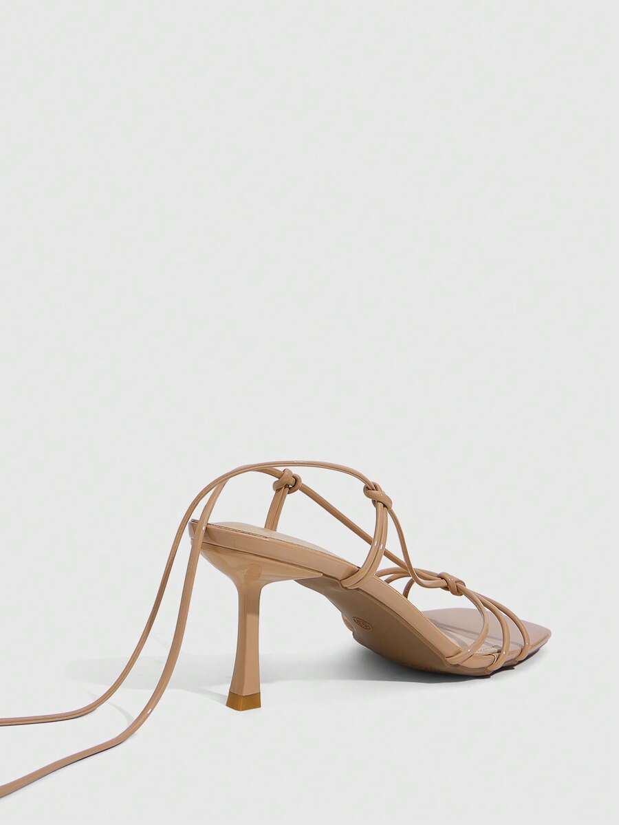 Women's square toe stiletto heel slingback sandals featuring sleek straps and buckle closure in a backless design.