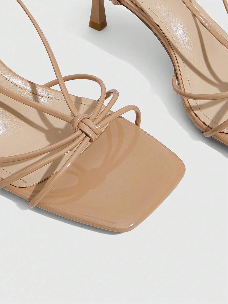 Women's square toe stiletto heel slingback sandals featuring sleek straps and buckle closure in a backless design.