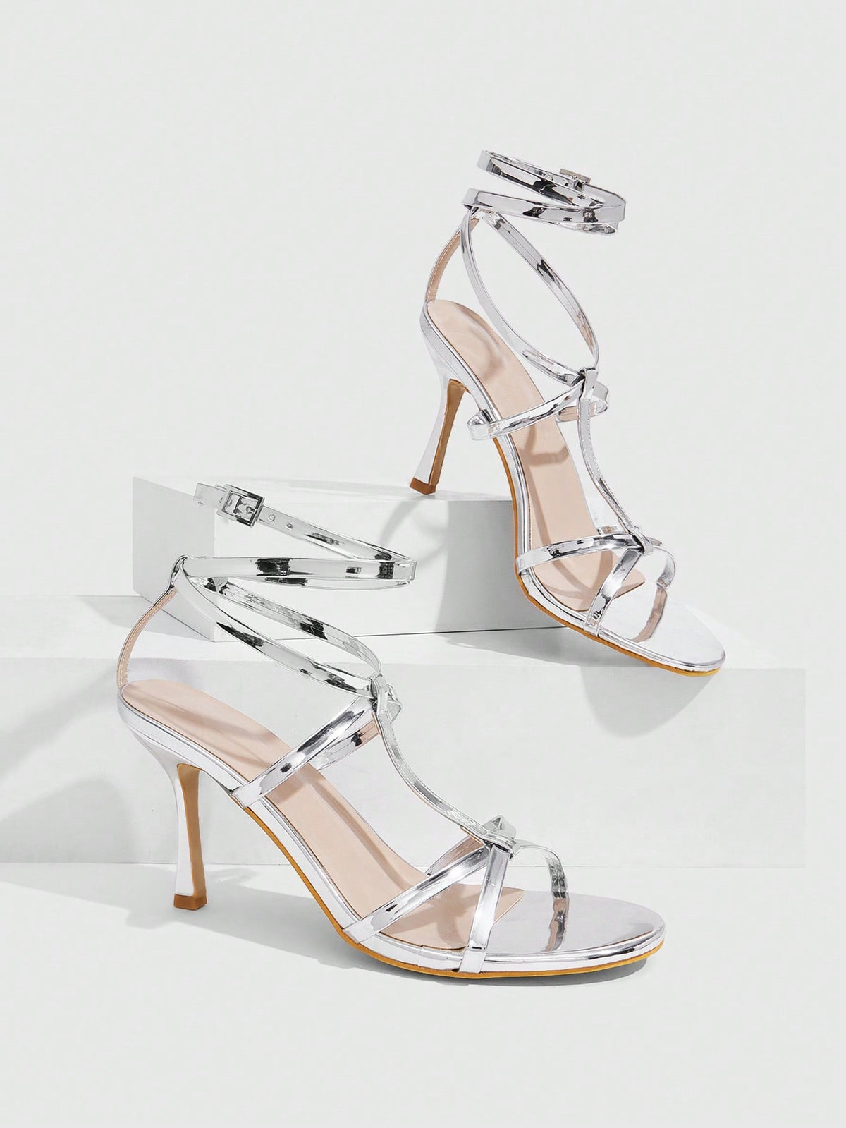 Women's open round toe high heel sandals with thin stiletto heel, hollow strap design, and ankle buckle closure.