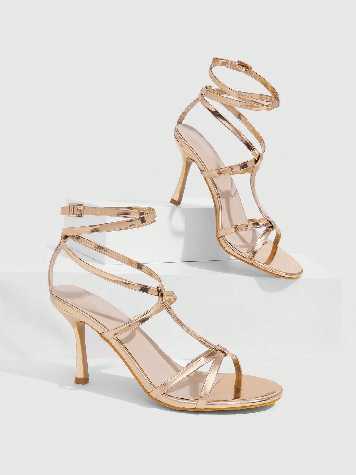 Women's open round toe high heel sandals with thin stiletto heel, hollow strap design, and ankle buckle closure.