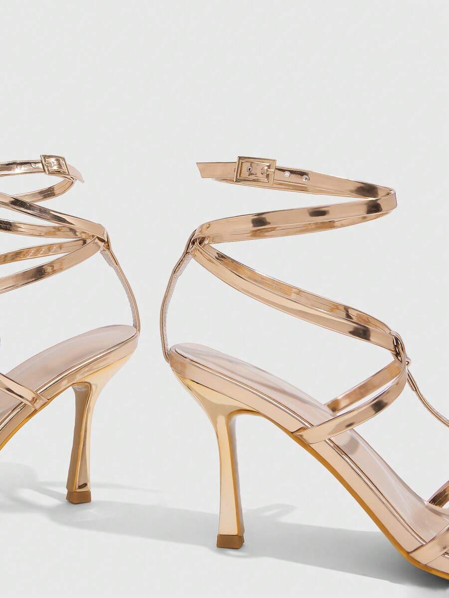 Women's open round toe high heel sandals with thin stiletto heel, hollow strap design, and ankle buckle closure.