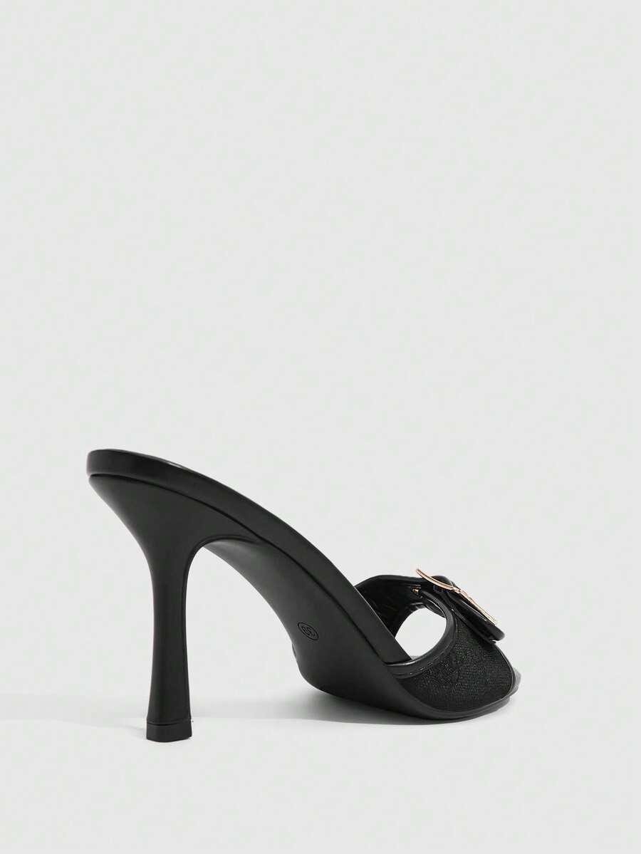 Women's brown leopard print high heel mule sandals with gold-tone buckle and grommet eyelet accents.
