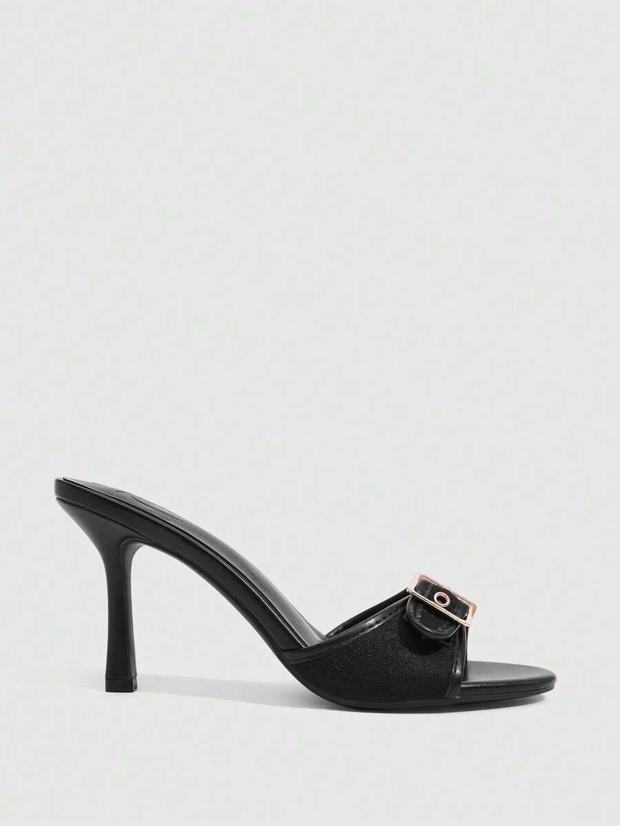 Women's brown leopard print high heel mule sandals with gold-tone buckle and grommet eyelet accents.
