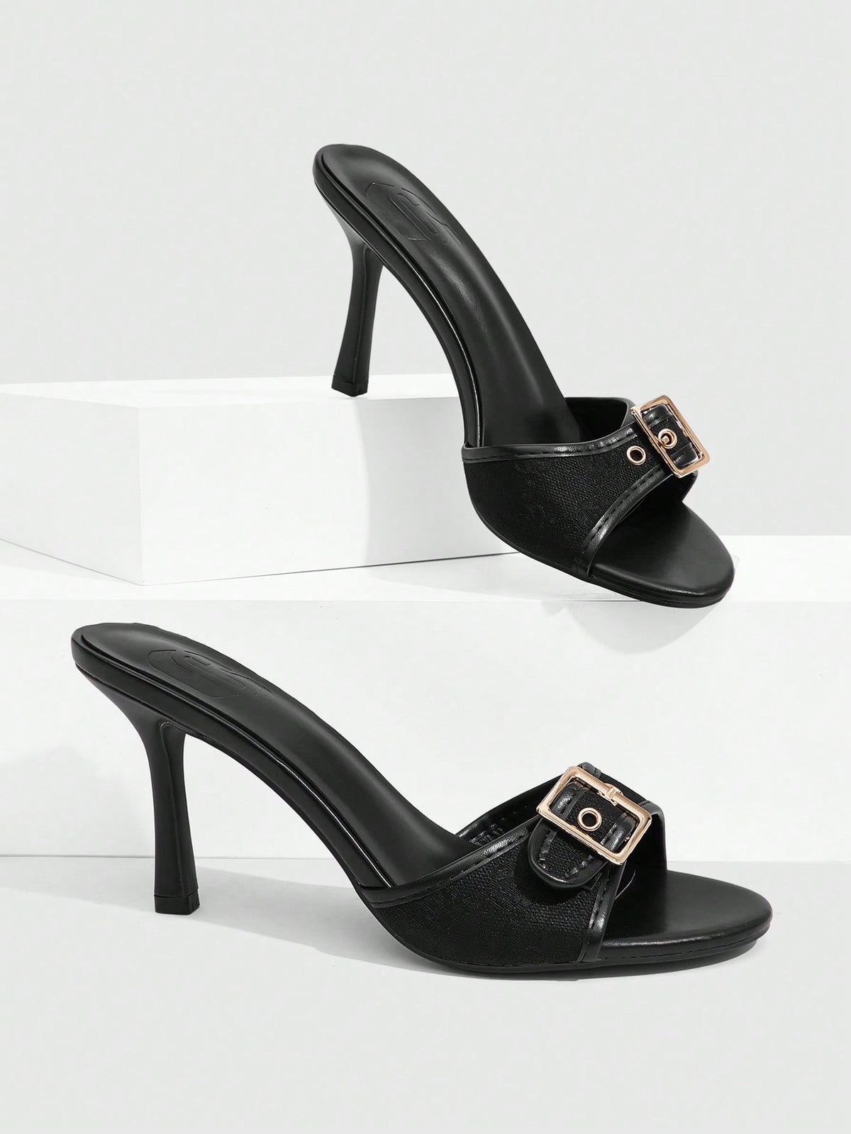 Women's brown leopard print high heel mule sandals with gold-tone buckle and grommet eyelet accents.