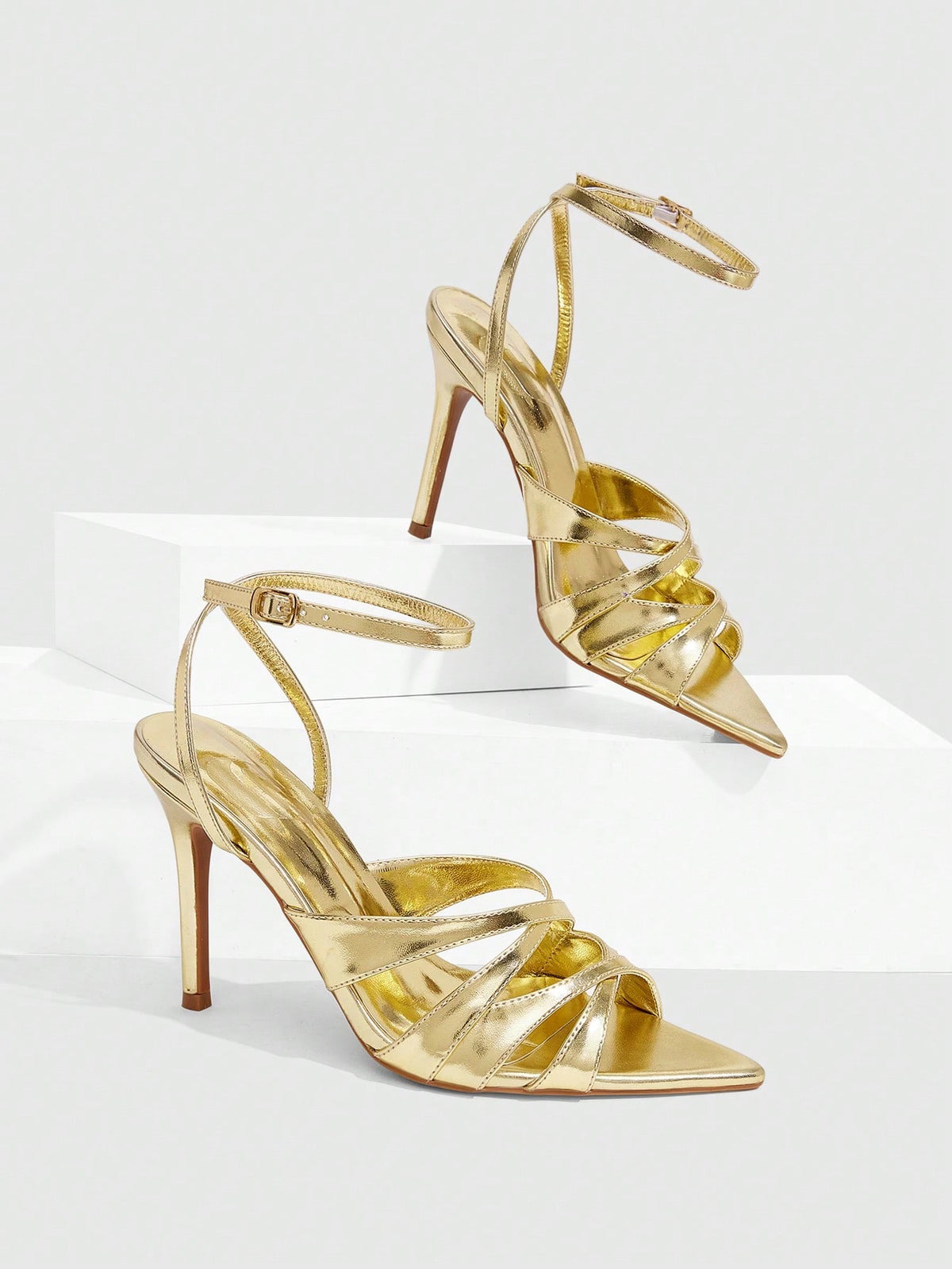 Women's open toe high stiletto sandals with cut-out cross straps and adjustable ankle buckle closure.