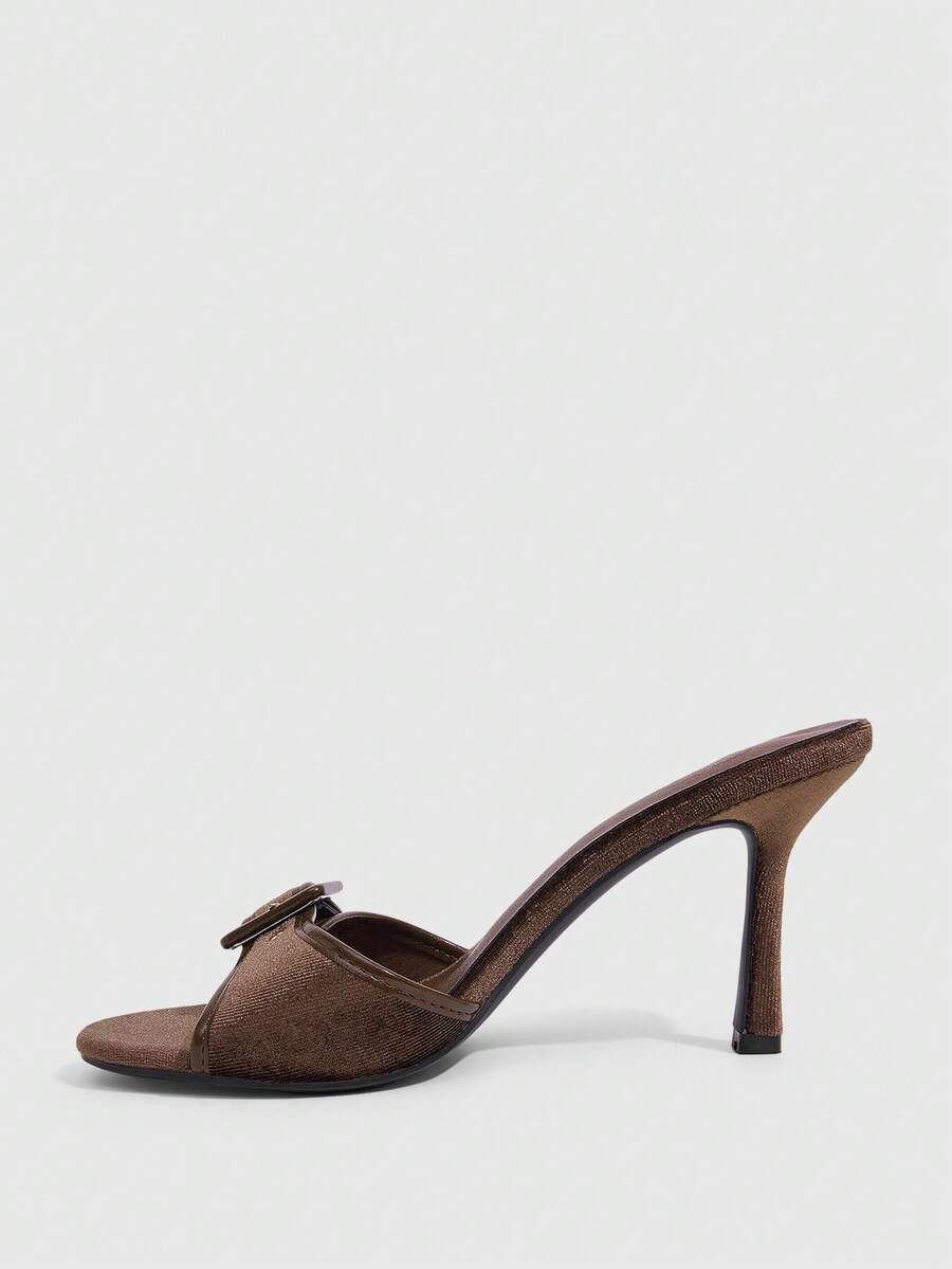 Women's brown leopard print high heel mule sandals with gold-tone buckle and grommet eyelet accents.