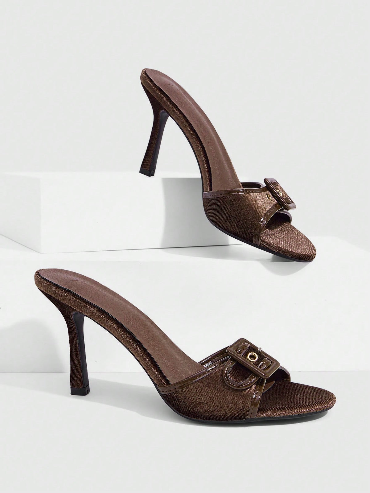 Women's brown leopard print high heel mule sandals with gold-tone buckle and grommet eyelet accents.
