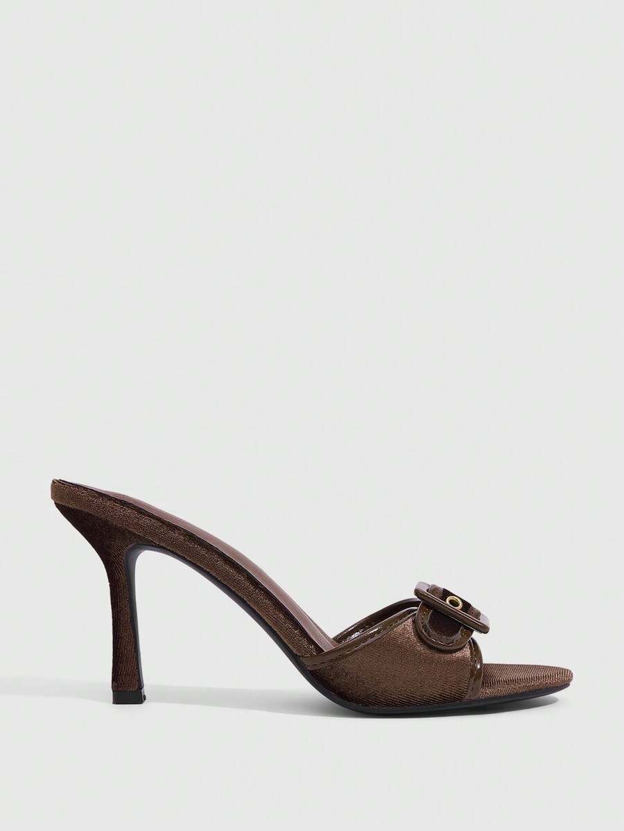 Women's brown leopard print high heel mule sandals with gold-tone buckle and grommet eyelet accents.