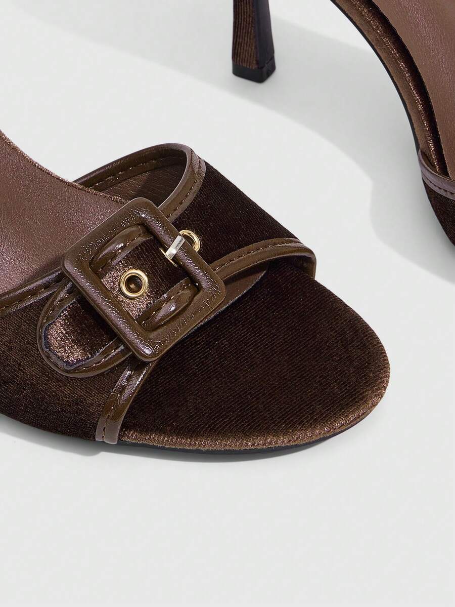 Women's brown leopard print high heel mule sandals with gold-tone buckle and grommet eyelet accents.