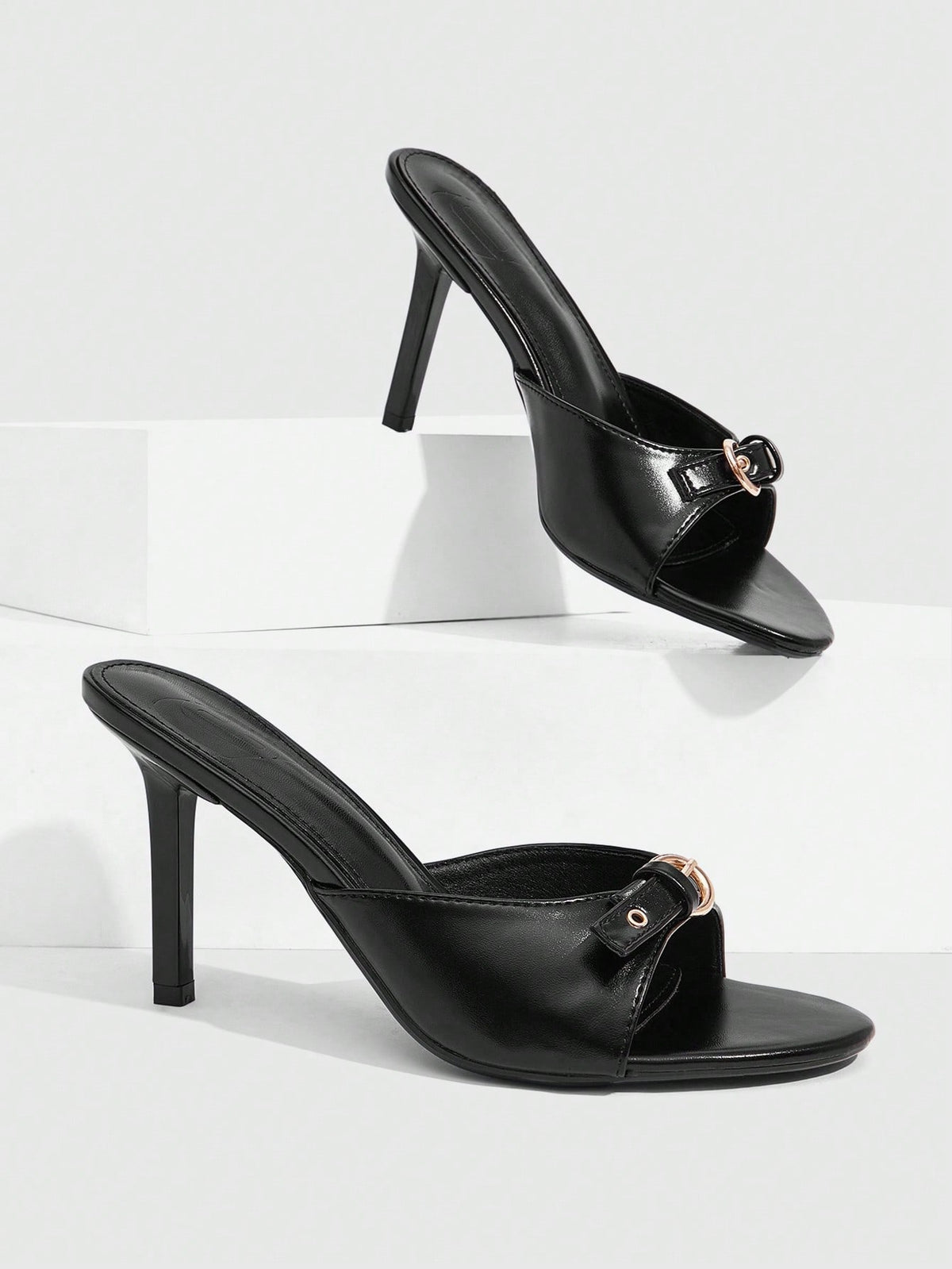 Elegant burgundy high heel slingback sandals with an open toe and round buckle strap.