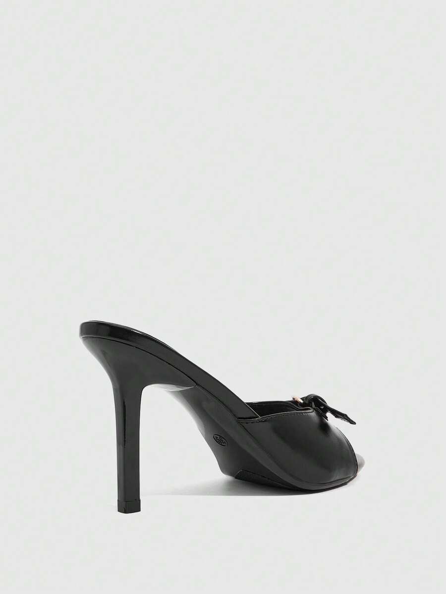 Elegant burgundy high heel slingback sandals with an open toe and round buckle strap.