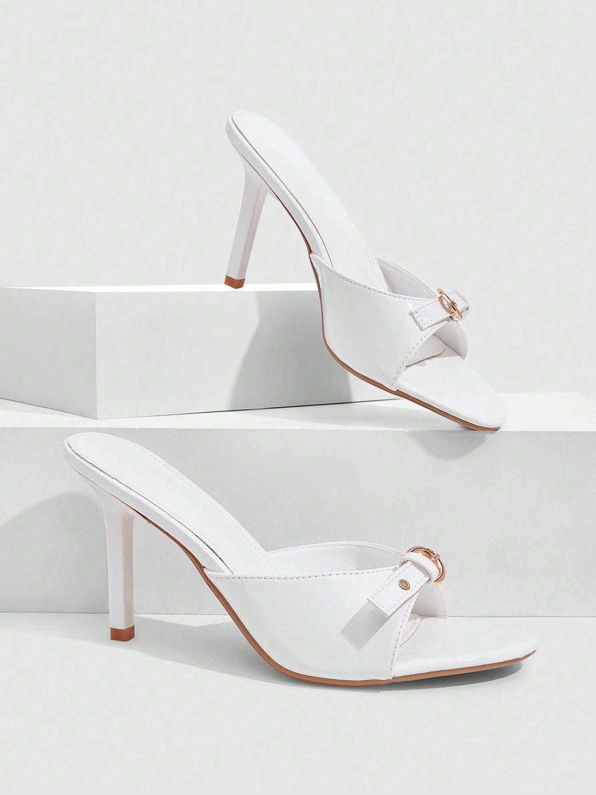 Elegant burgundy high heel slingback sandals with an open toe and round buckle strap.