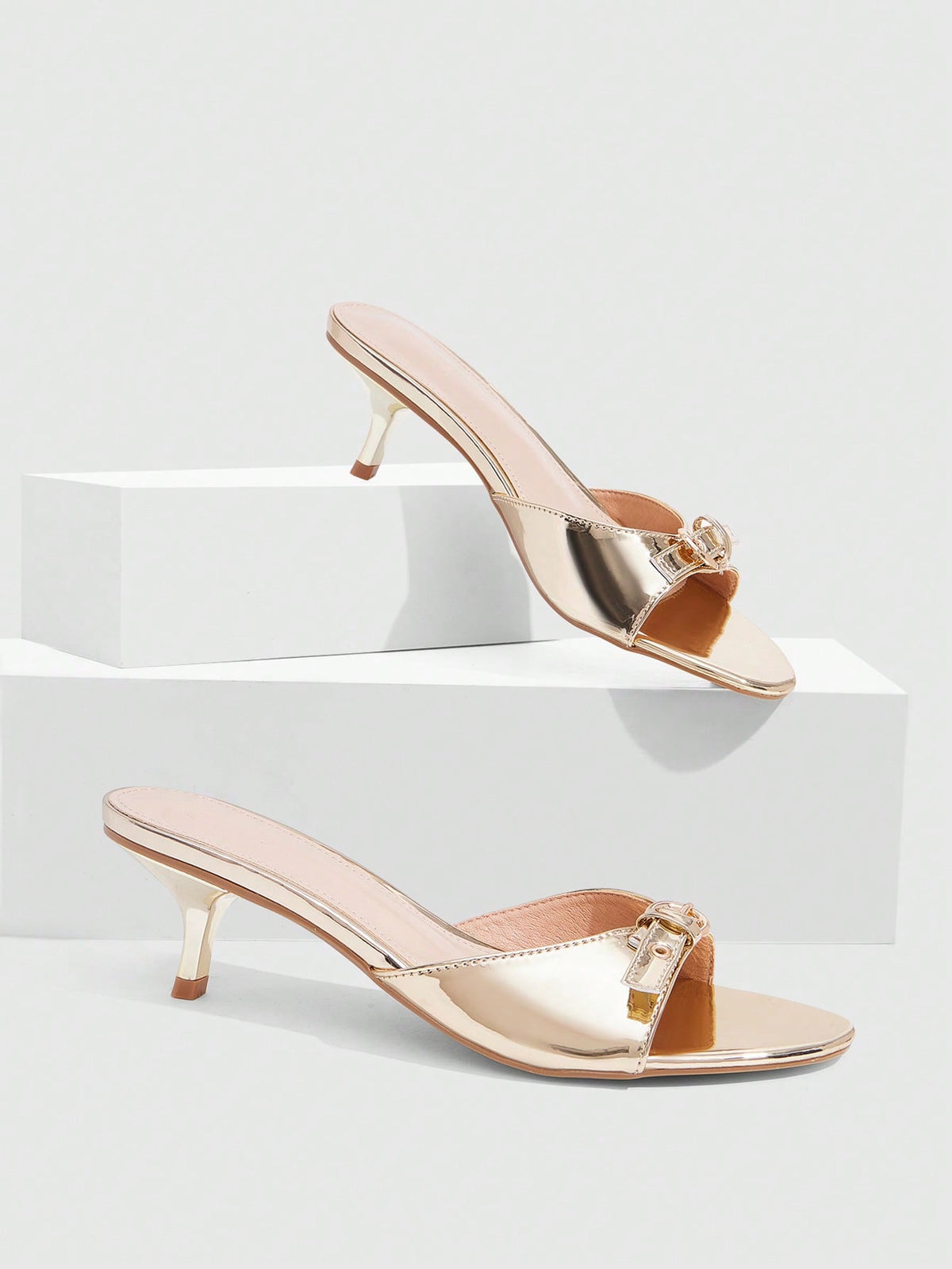Women's light gold kitten heel slingback sandals featuring an open toe and round buckle strap.