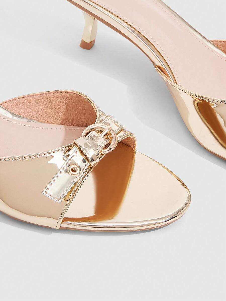 Women's light gold kitten heel slingback sandals featuring an open toe and round buckle strap.