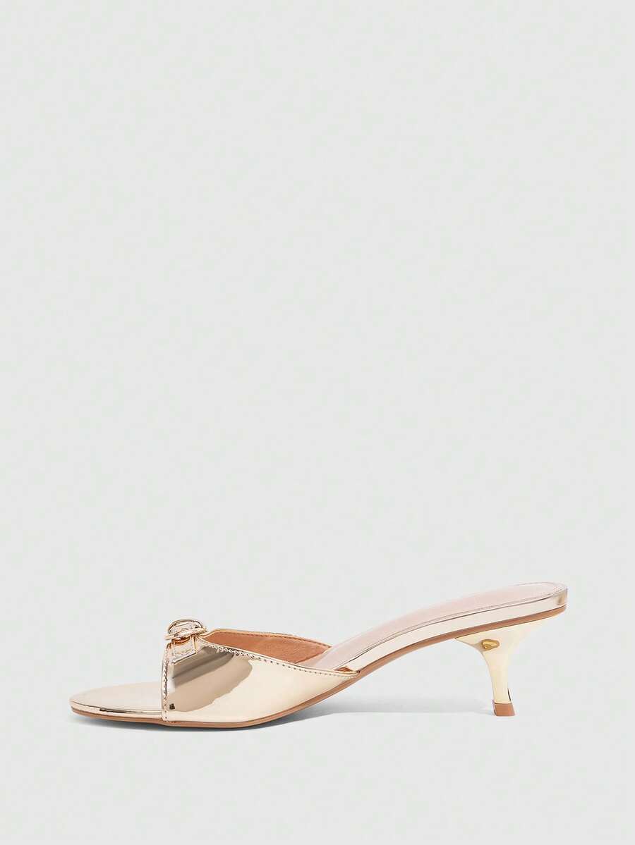 Women's light gold kitten heel slingback sandals featuring an open toe and round buckle strap.