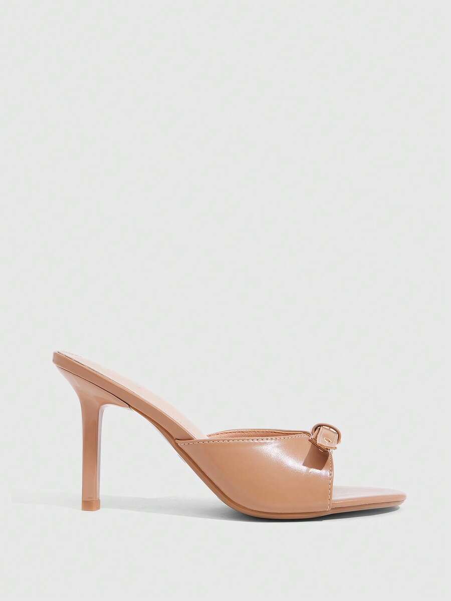 Elegant burgundy high heel slingback sandals with an open toe and round buckle strap.