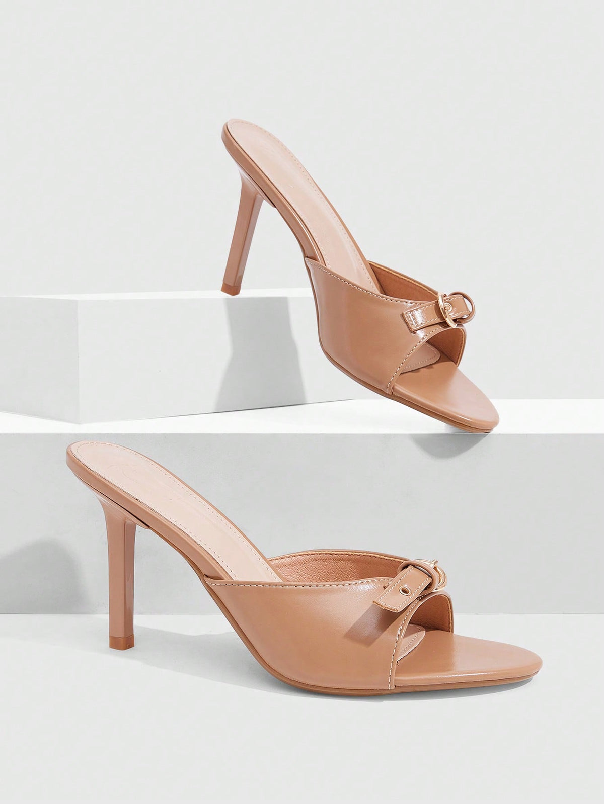 Elegant burgundy high heel slingback sandals with an open toe and round buckle strap.
