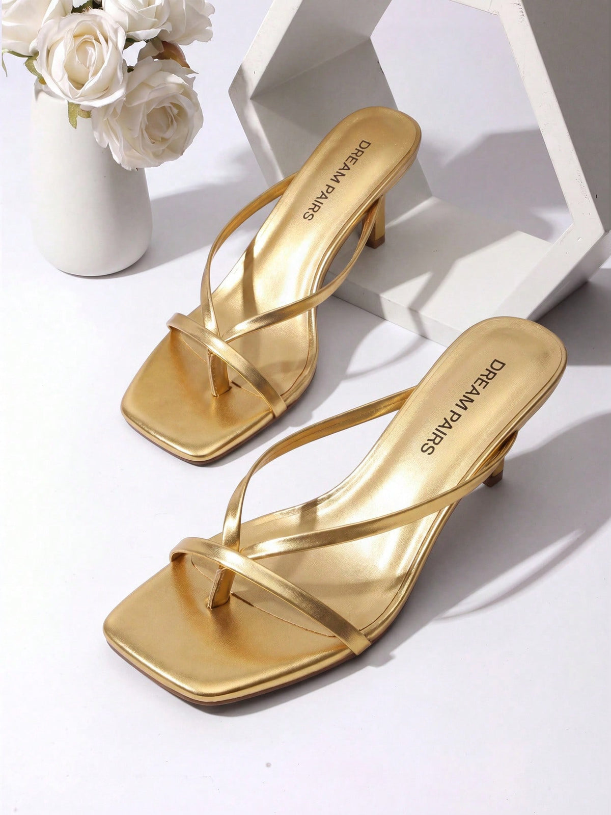 Women's metallic kitten low heel thong sandals featuring an open square toe and slip-on mule design.