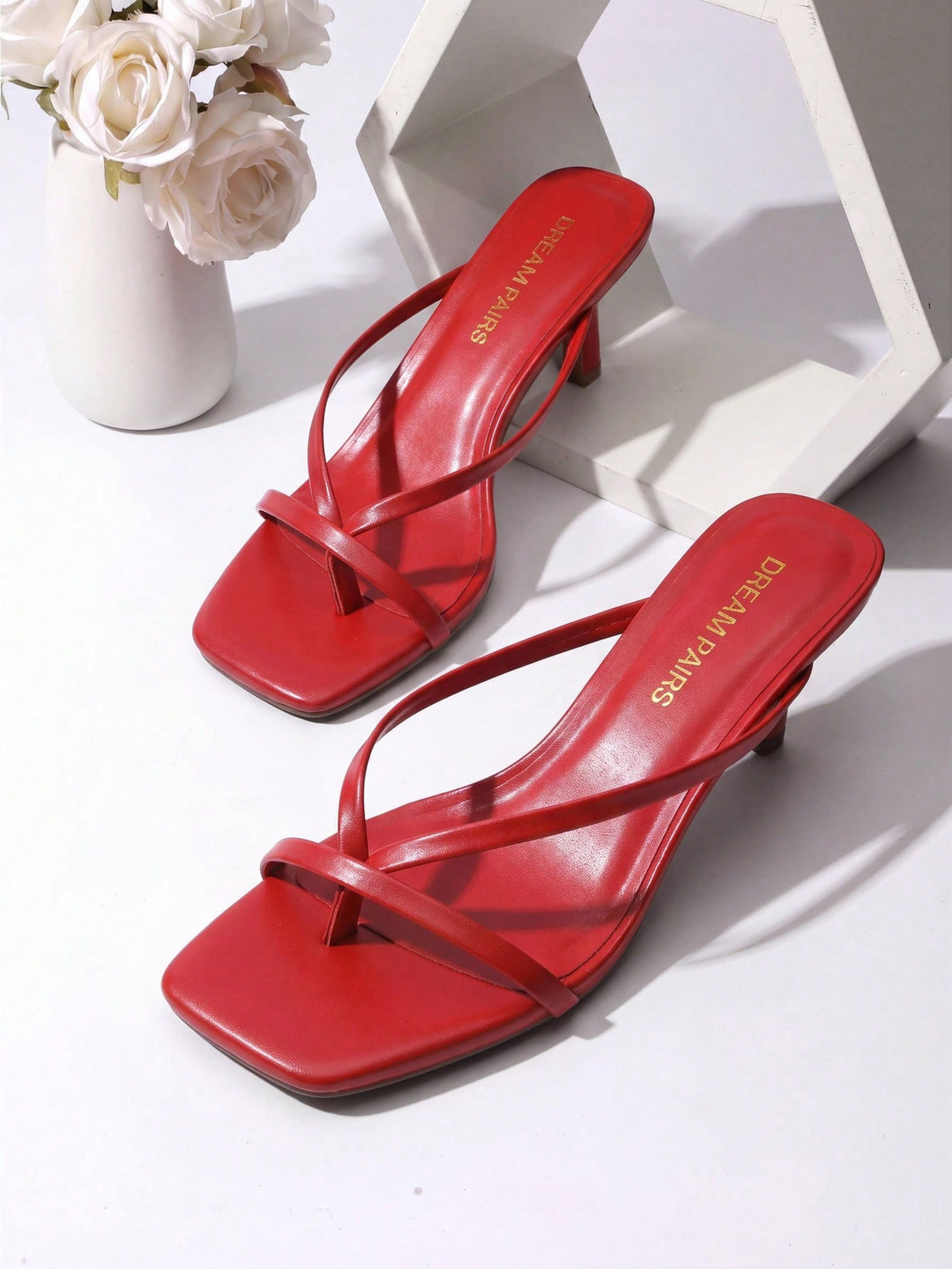 Women's metallic kitten low heel thong sandals featuring an open square toe and slip-on mule design.