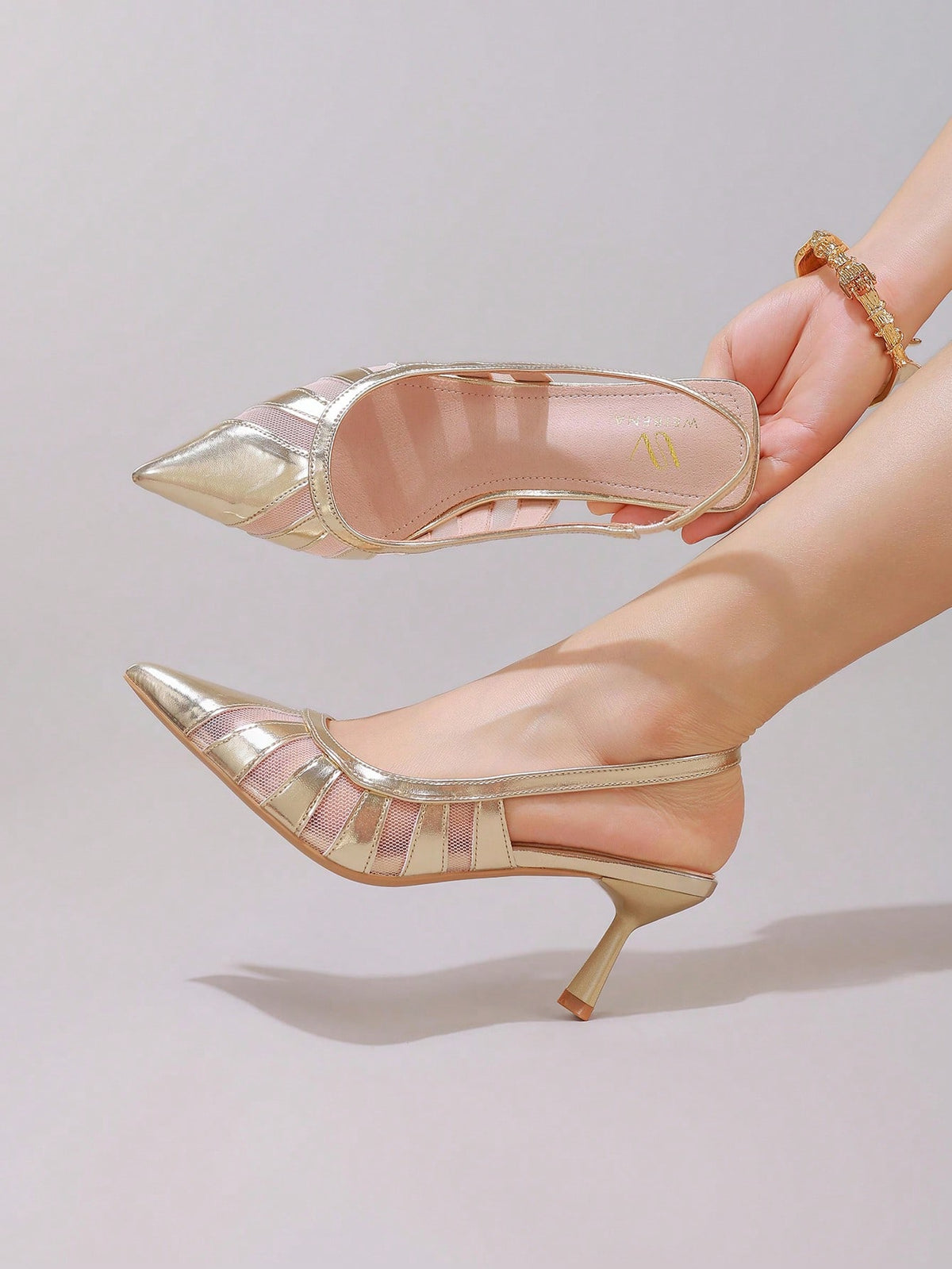 Black lace pointed toe high heel pumps featuring stiletto heels and a decorative bow accent.