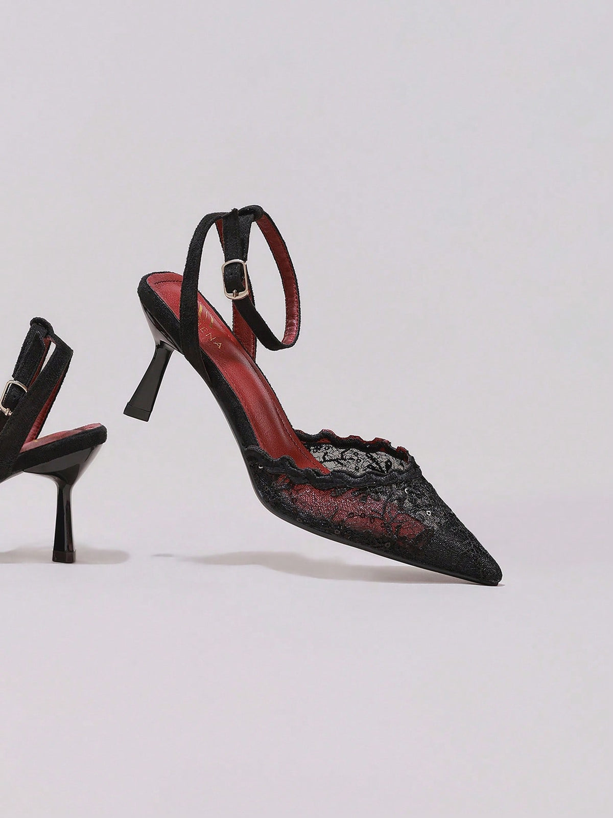 Black lace pointed toe high heel pumps featuring stiletto heels and a decorative bow accent.