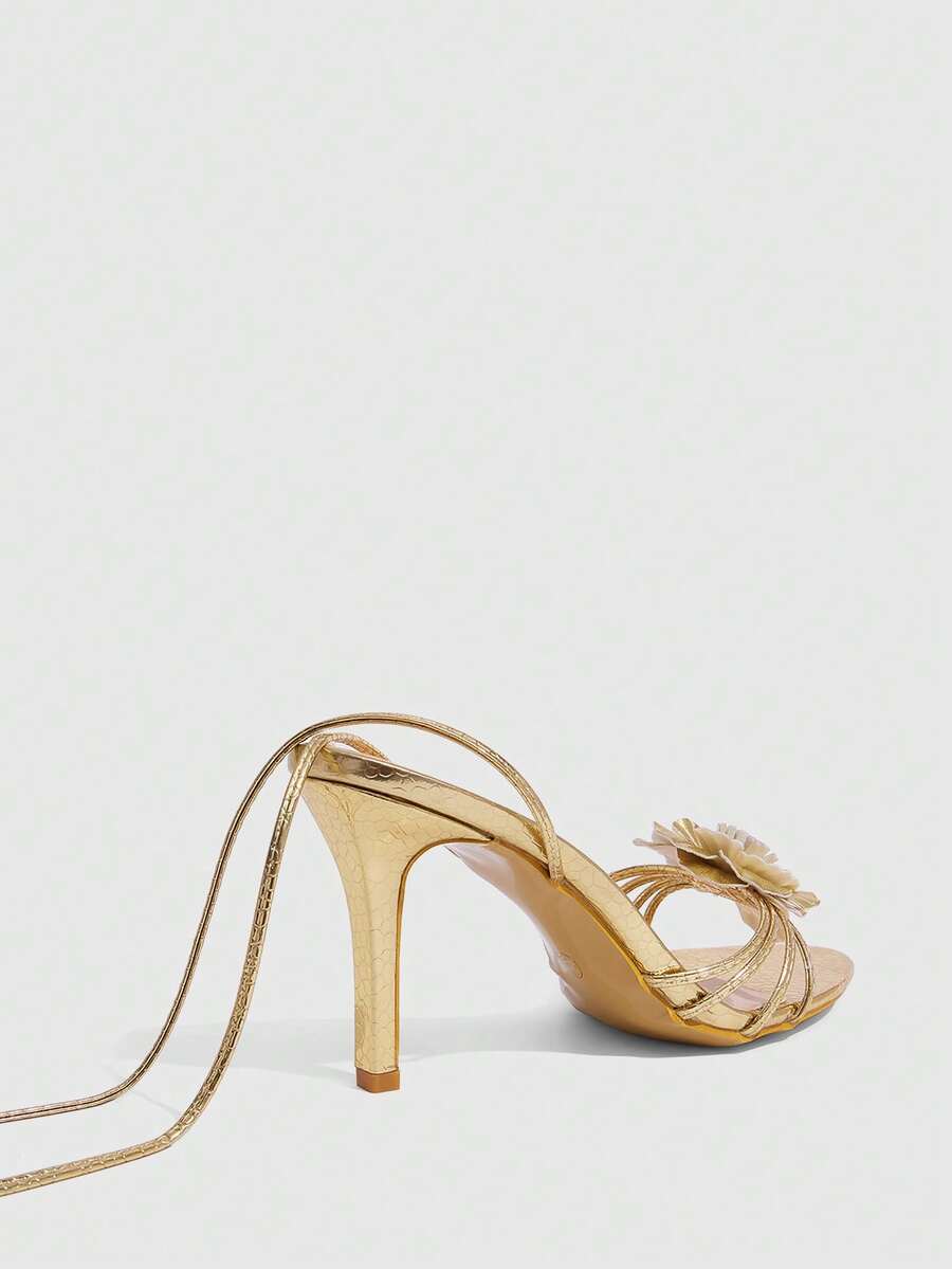 Women's golden snake pattern pointed toe thin heel strap sandals with three-dimensional camellia accent