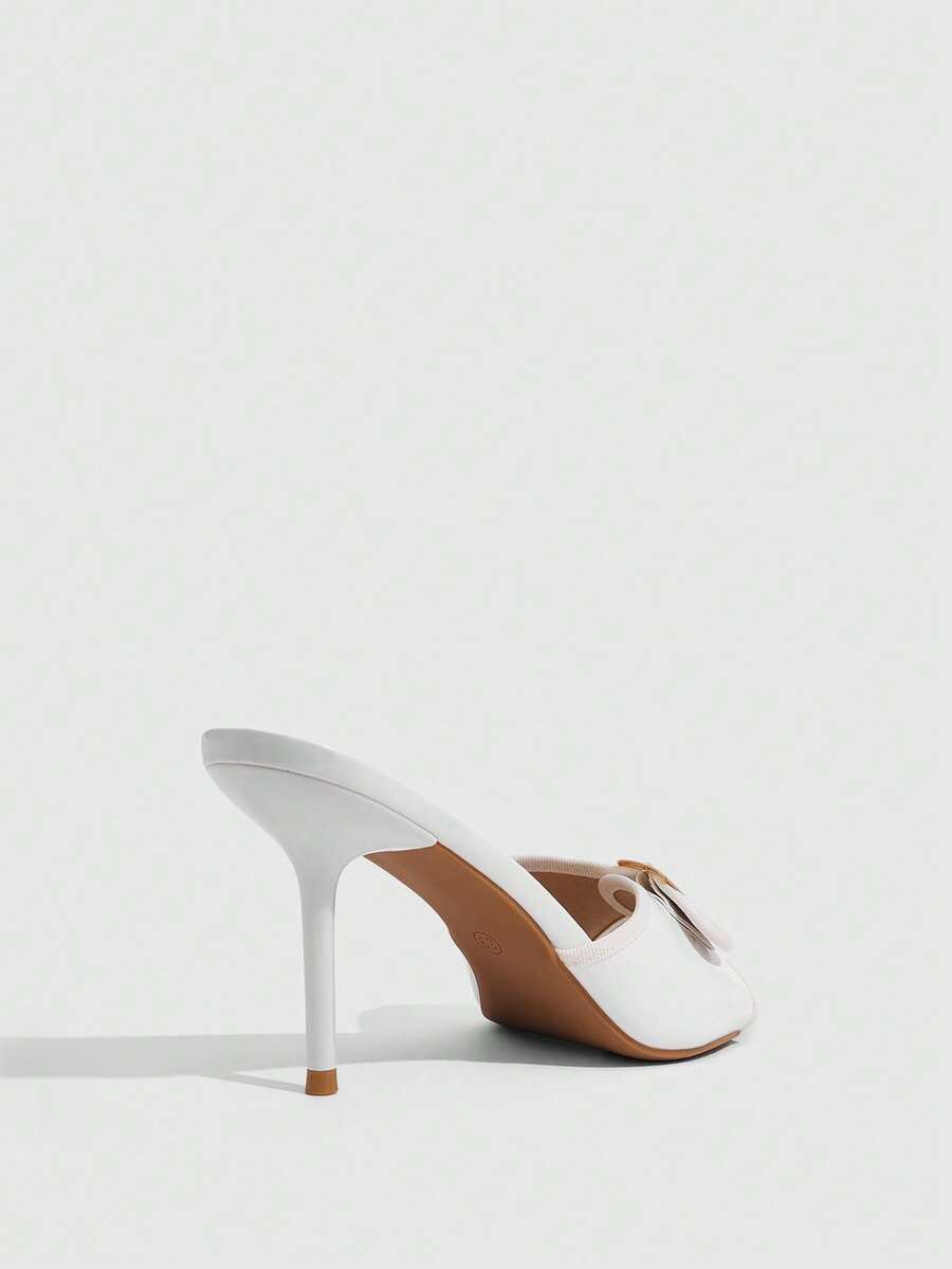 Beige pointed toe mule high heel sandals featuring gold buckle accent