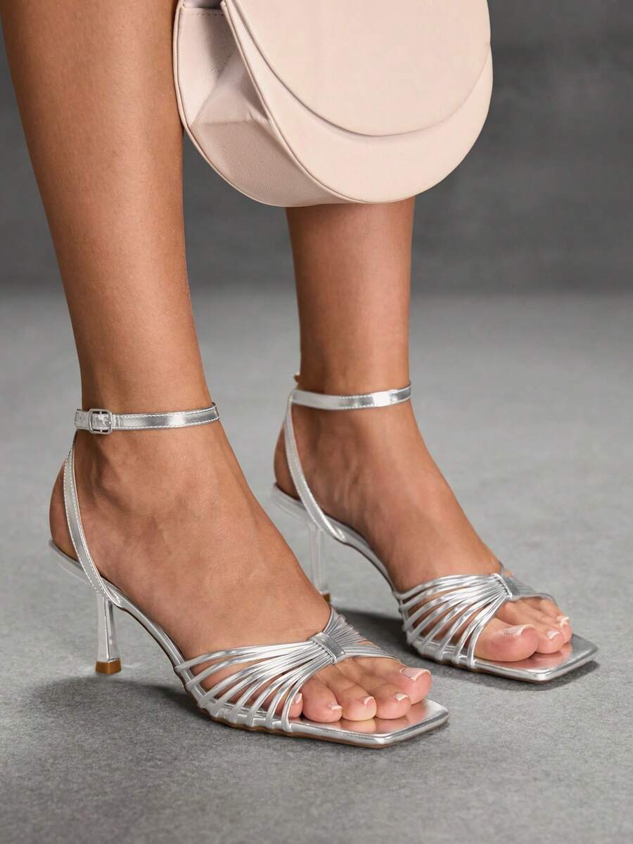 Women's open toe stiletto heel sandals featuring square toe design, criss-cross rhinestone slim straps, and secure ankle strap.