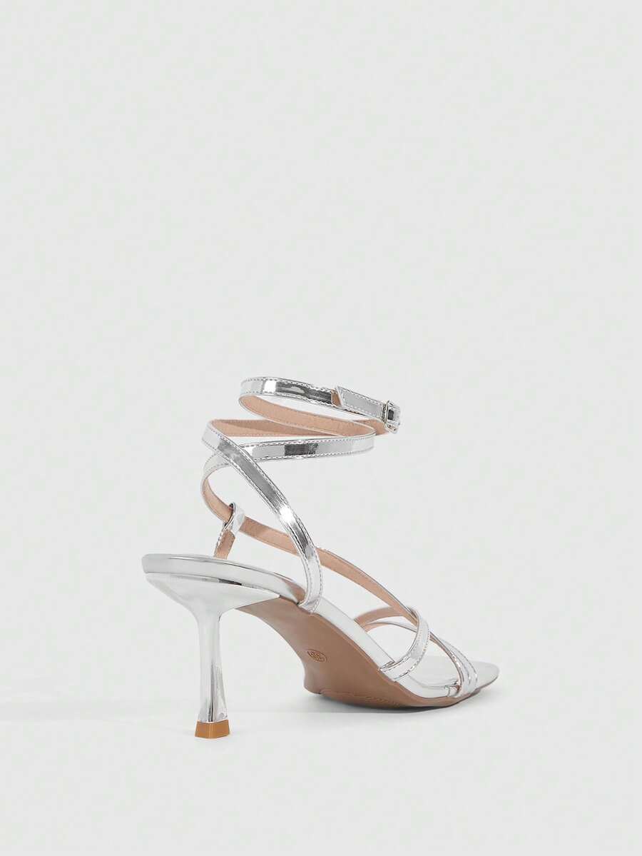 Women's open toe stiletto heel sandals featuring square toe design, criss-cross rhinestone slim straps, and secure ankle strap.