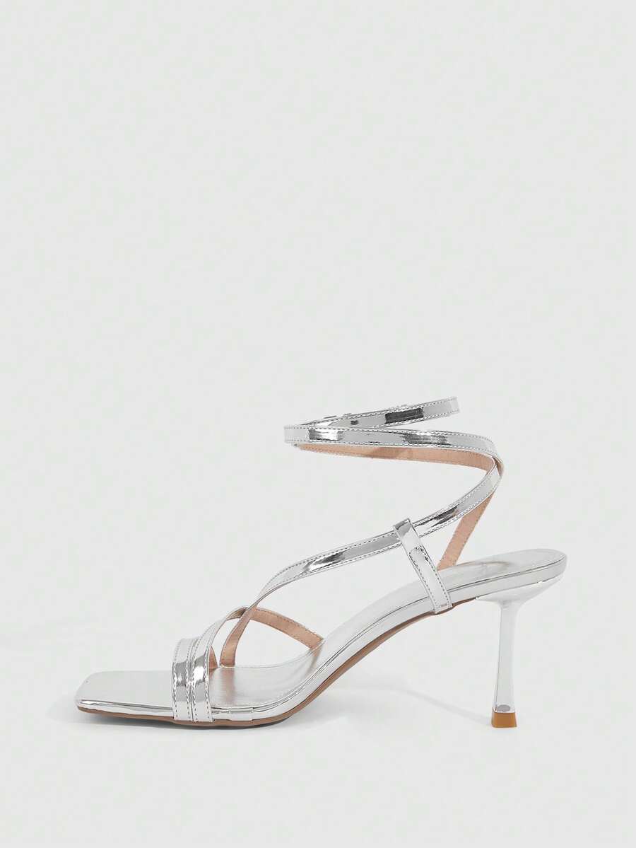 Women's open toe stiletto heel sandals featuring square toe design, criss-cross rhinestone slim straps, and secure ankle strap.