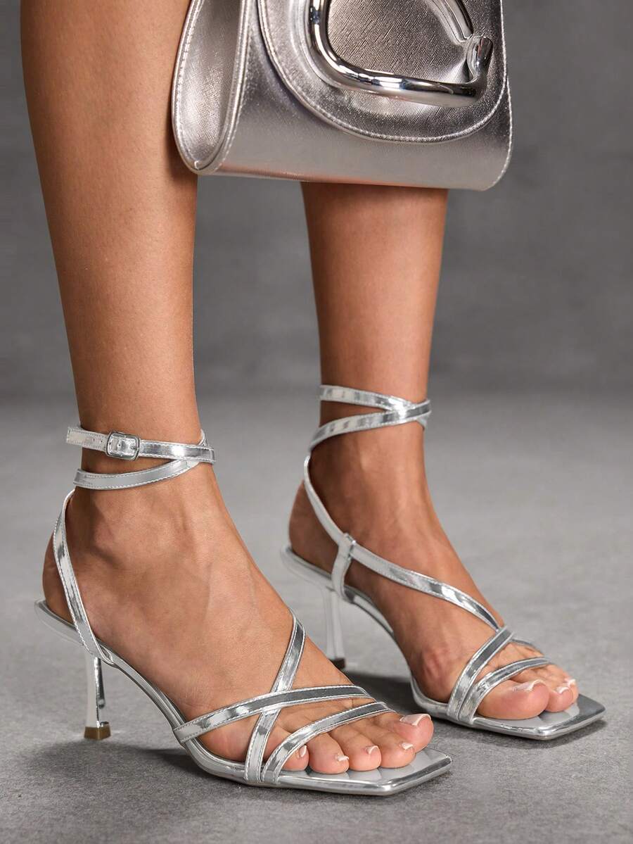 Women's open toe stiletto heel sandals featuring square toe design, criss-cross rhinestone slim straps, and secure ankle strap.