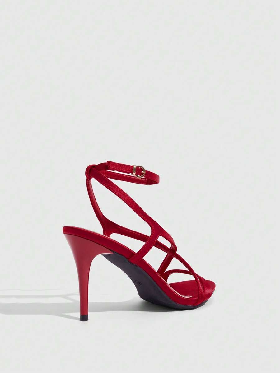 Square toe stiletto high heel sandals in deep burgundy satin featuring criss cross straps and an open toe design.