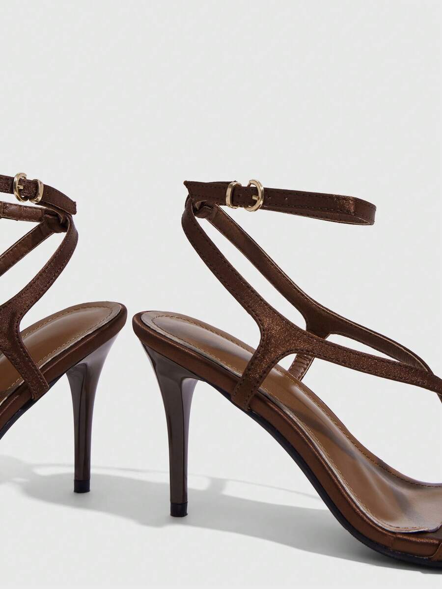 Square toe stiletto high heel sandals in deep burgundy satin featuring criss cross straps and an open toe design.