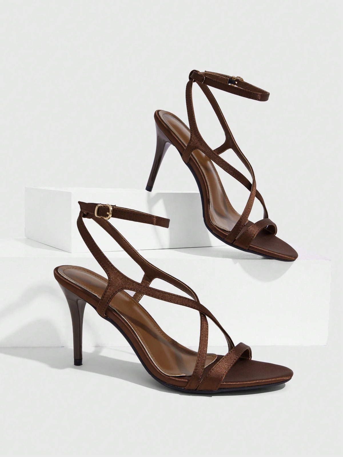 Square toe stiletto high heel sandals in deep burgundy satin featuring criss cross straps and an open toe design.