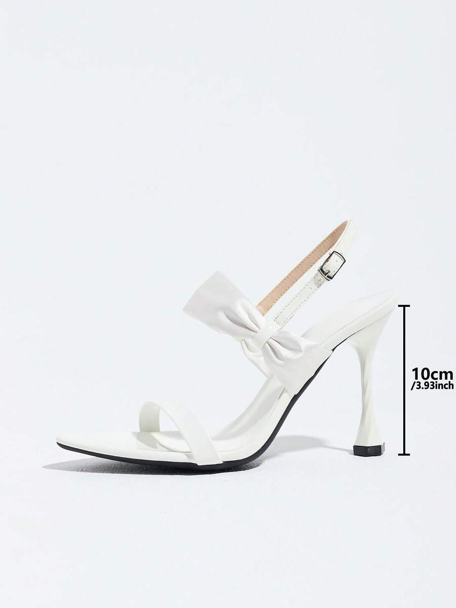 Women's black open toe stiletto heel sandals featuring lace mesh detailing, wide strap styling, and high stiletto heels.